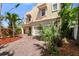 Two-story home showcasing charming awnings, two-car garage, and mature landscaping at 2410 W North A St # 2, Tampa, FL 33609