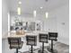 Modern kitchen features white cabinets, pendant lights, stainless appliances, and seating at the island at 2410 W North A St # 2, Tampa, FL 33609
