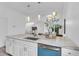 Bright open kitchen with marble countertop, stainless steel appliances, modern fixtures, and white cabinetry at 2410 W North A St # 2, Tampa, FL 33609