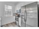 Bright kitchen features stainless steel appliances, white cabinets, and wood flooring at 2410 W North A St # 2, Tampa, FL 33609
