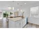 Kitchen with white cabinets, marble countertops, island, and modern appliances with views to the dining area at 2410 W North A St # 2, Tampa, FL 33609