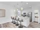 Open concept kitchen features white cabinets, stainless appliances, and an island with barstool seating at 2410 W North A St # 2, Tampa, FL 33609