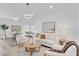Bright and airy living room features modern lighting, neutral décor, hardwood floors and lots of light at 2410 W North A St # 2, Tampa, FL 33609