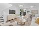 Living room leading to dining area with open floor plan, hardwood floors, contemporary lighting and neutral decor at 2410 W North A St # 2, Tampa, FL 33609