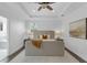 This main bedroom has a tray ceiling, recessed lights, ceiling fan, and ensuite bathroom for modern living at 2410 W North A St # 2, Tampa, FL 33609