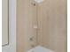 This shower-tub combo is tiled and features a shower head, faucet, and built-in soap holder at 2410 W North A St # 2, Tampa, FL 33609