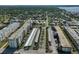 Overhead view of the apartment complex, parking, and surrounding neighborhood with mature trees and streets at 2960 59Th S St # 615, Gulfport, FL 33707