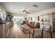 Comfortable living room with a brown leather sofa, ceiling fan, art, and nice flooring at 2960 59Th S St # 615, Gulfport, FL 33707