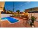 Private backyard oasis with a sparkling pool, patio, and ambient string lights at 3066 Highland N St, St Petersburg, FL 33704
