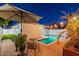 Private backyard oasis with a sparkling pool, patio, and ambient string lights at 3066 Highland N St, St Petersburg, FL 33704