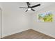 Minimalist bedroom with a ceiling fan, wood floors, and a bright window at 3066 Highland N St, St Petersburg, FL 33704