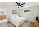 Bright bedroom with a ceiling fan, neutral color palette, and an ensuite bathroom at 3066 Highland N St, St Petersburg, FL 33704