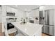 Modern kitchen with white cabinets, stainless steel appliances, quartz countertops, and a large island at 3066 Highland N St, St Petersburg, FL 33704