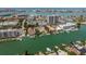 Overhead view of condos with boat docks along the canal leading to the ocean and city skyline at 311 Island Way # 101, Clearwater Beach, FL 33767