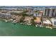 Scenic aerial view of waterfront condo complex with boat docks and a city skyline backdrop at 311 Island Way # 101, Clearwater Beach, FL 33767