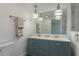 Charming bathroom features a double sink vanity with unique pendant lighting at 311 Island Way # 101, Clearwater Beach, FL 33767