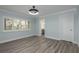 Bright bedroom features shuttered windows, gray floors and a modern ceiling fan at 311 Island Way # 101, Clearwater Beach, FL 33767