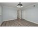 Neutral-toned bedroom with gray wood-look floors and a large double closet at 311 Island Way # 101, Clearwater Beach, FL 33767