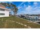 The property includes a backyard lawn and private boat dock with boat lift system at 311 Island Way # 101, Clearwater Beach, FL 33767