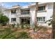 Exterior of the home featuring a balcony above a covered patio and lush landscaping at 311 Island Way # 101, Clearwater Beach, FL 33767