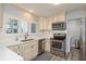 Bright kitchen features stainless steel appliances, white cabinets, and plenty of counter space at 311 Island Way # 101, Clearwater Beach, FL 33767