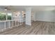 Open living area features modern flooring, view to kitchen, and access to the front entrance at 311 Island Way # 101, Clearwater Beach, FL 33767