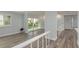 Light-filled living area showcasing wood-look floors and large sliding doors to the outdoors at 311 Island Way # 101, Clearwater Beach, FL 33767
