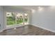 Bright living room boasts sliding glass doors leading to a well-maintained outdoor lawn at 311 Island Way # 101, Clearwater Beach, FL 33767