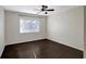 This bedroom features sleek wood floors, a ceiling fan, and bright natural light from the window at 3206 W Azeele St # 126, Tampa, FL 33609