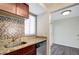 Charming kitchen features granite countertops, wood cabinetry, and stainless steel appliances at 3206 W Azeele St # 126, Tampa, FL 33609