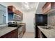 A cozy kitchen features stainless steel appliances, granite countertops, and warm, wooden cabinets at 3206 W Azeele St # 126, Tampa, FL 33609