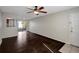 Bright living room with hardwood floors, ceiling fan, and sliding doors to a private patio at 3206 W Azeele St # 126, Tampa, FL 33609
