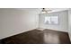 Living room with dark hardwood flooring, a ceiling fan, and a window at 3206 W Azeele St # 126, Tampa, FL 33609