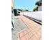 Backyard view showing a red brick paver walkway along a privacy fence at 3318 Boca Ciega N Dr, St Petersburg, FL 33710