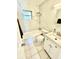 Bright bathroom with white marble-style tiled walls, a shower-tub combination, and modern vanity at 3318 Boca Ciega N Dr, St Petersburg, FL 33710