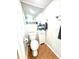 Compact half bath with a modern toilet, small vanity, and tiled floor at 3318 Boca Ciega N Dr, St Petersburg, FL 33710