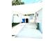 Long carport with a concrete floor extending to a backyard area with access to a shed at 3318 Boca Ciega N Dr, St Petersburg, FL 33710