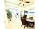 View of the dining room with kitchen access and a stainless steel refrigerator at 3318 Boca Ciega N Dr, St Petersburg, FL 33710