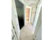 The hallway features tiled floors and storage cabinets by bathroom and bedroom at 3318 Boca Ciega N Dr, St Petersburg, FL 33710