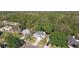 An aerial view showcases a house on a verdant lot backing to mature trees and a green space at 389 Waterford W Cir, Tarpon Springs, FL 34688