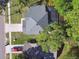 Aerial view of the home, roof, backyard, driveway, and neighborhood at 389 Waterford W Cir, Tarpon Springs, FL 34688
