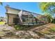 View of the screened-in pool and the home's backyard area at 389 Waterford W Cir, Tarpon Springs, FL 34688