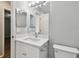 Modern bathroom featuring a marble countertop, sink, and bright lighting for a comfortable living space at 389 Waterford W Cir, Tarpon Springs, FL 34688
