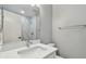Modern bathroom featuring a marble countertop, sink, and a view of a spacious shower with elegant tile work at 389 Waterford W Cir, Tarpon Springs, FL 34688