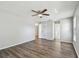 Large bedroom with hardwood floors, ceiling fan, and ample natural light from large windows at 389 Waterford W Cir, Tarpon Springs, FL 34688