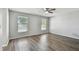 Bright bedroom with hardwood floors, large windows, and a serene atmosphere at 389 Waterford W Cir, Tarpon Springs, FL 34688