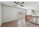 Bonus room features wood floors, two windows, and wood banister at 389 Waterford W Cir, Tarpon Springs, FL 34688