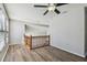Bonus room features wood floors, two windows, and wood banister at 389 Waterford W Cir, Tarpon Springs, FL 34688