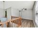 Bonus room with wood floors and wood banister overlooking stairs at 389 Waterford W Cir, Tarpon Springs, FL 34688