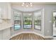 Breakfast nook featuring a bay window with a pool view and granite countertops at 389 Waterford W Cir, Tarpon Springs, FL 34688